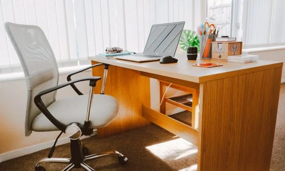 white rolling armchair beside table