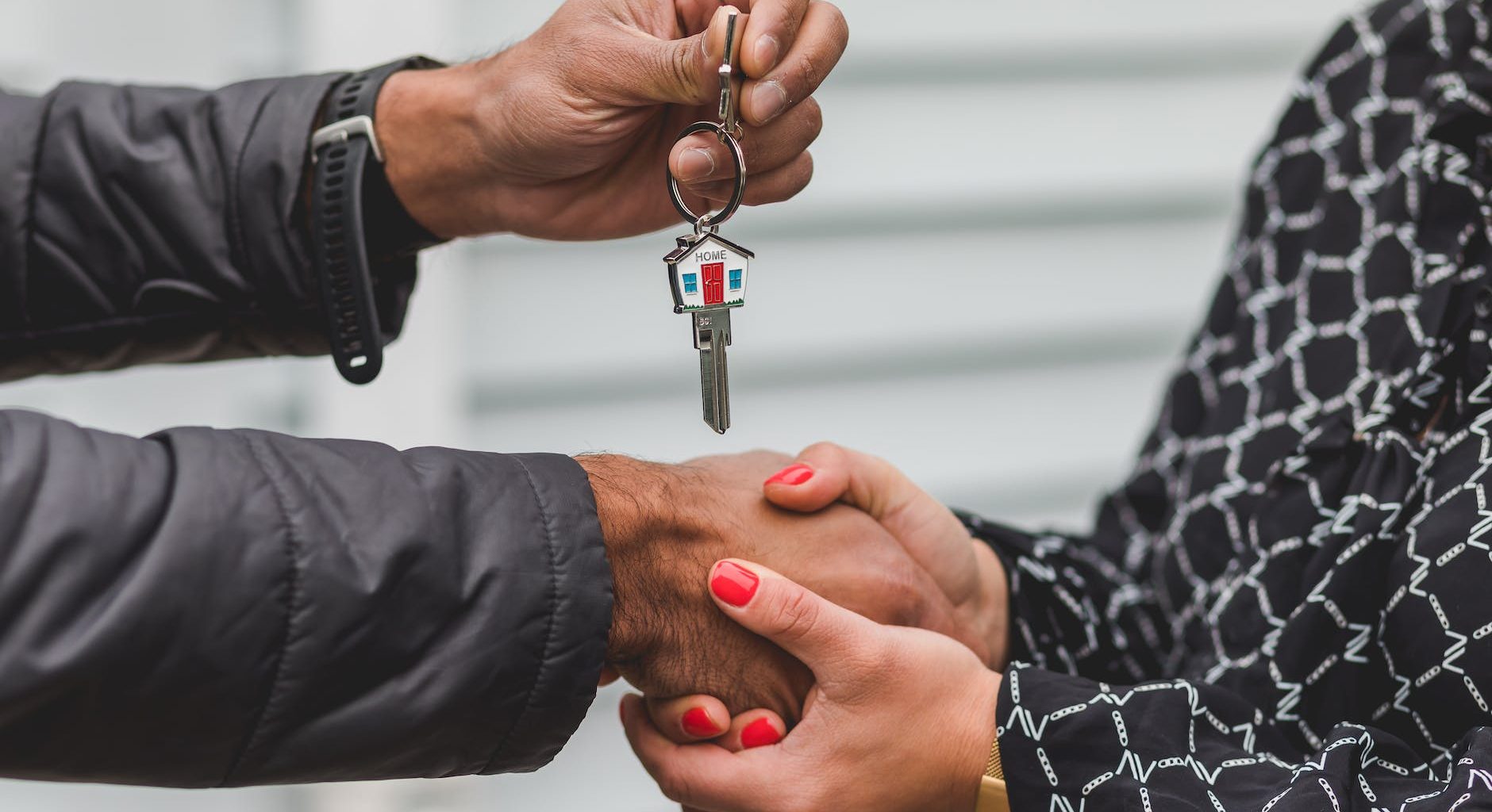 person holding silver key