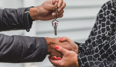 person holding silver key