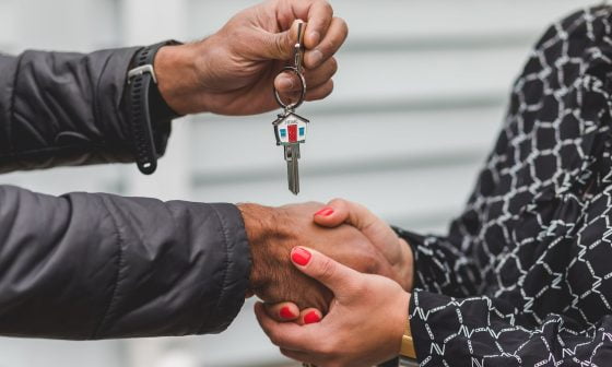 person holding silver key